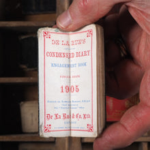 Load image into Gallery viewer, De La Rue's Improved Condensed diary and engagement book. >>FINGER SHAPED MINIATURE BOOK IN LAVISH SILVER SLIPCASE<< Publication Date: 1905 CONDITION: VERY GOOD
